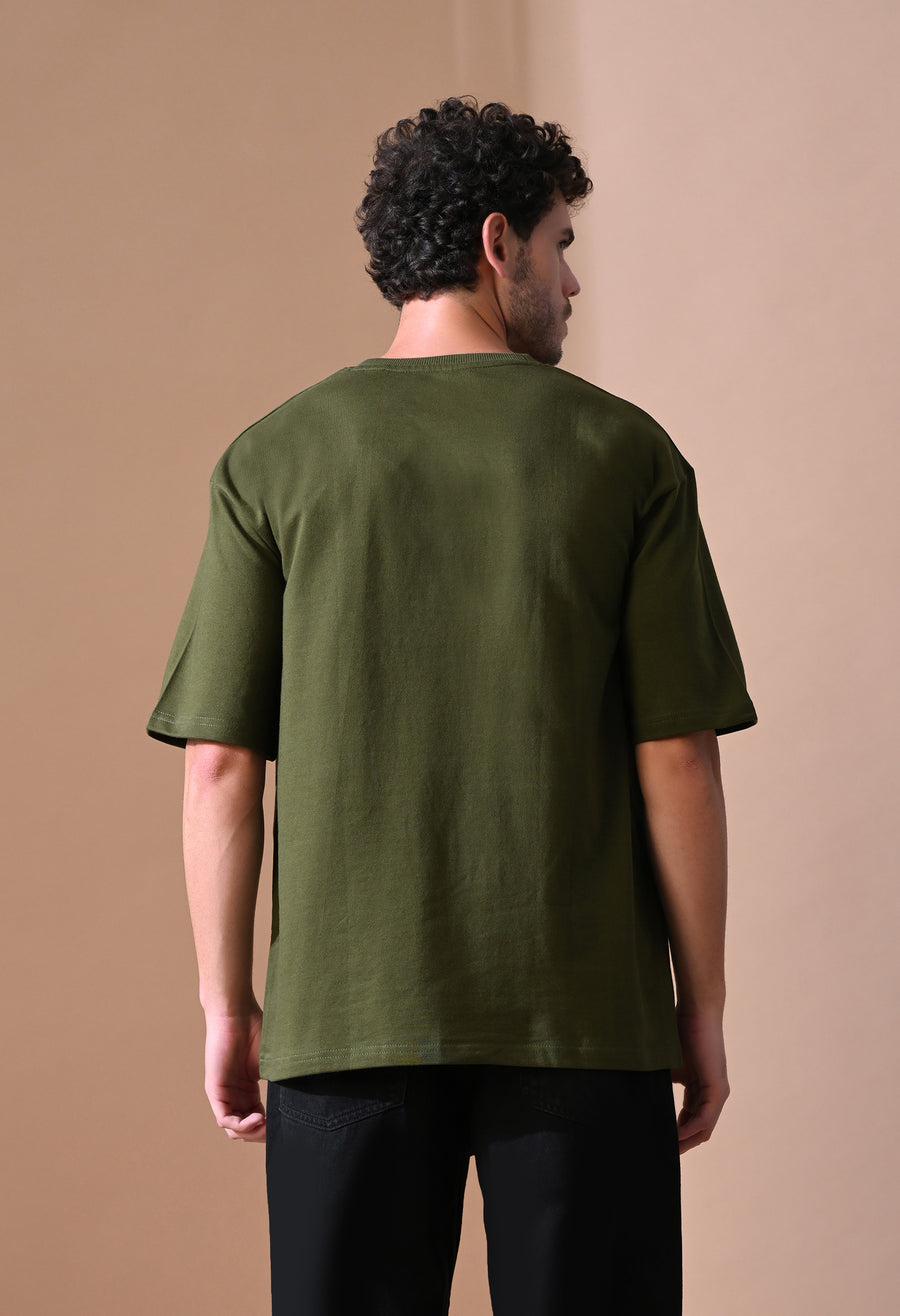 Back view of the Olive Theory Oversize Tee worn with black pants