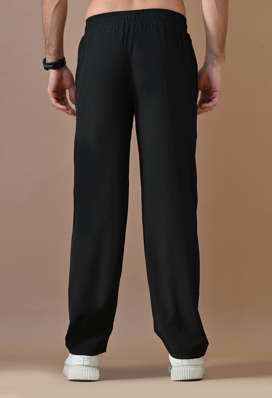Back view of the Shadow Flow Trousers worn with a casual outfit